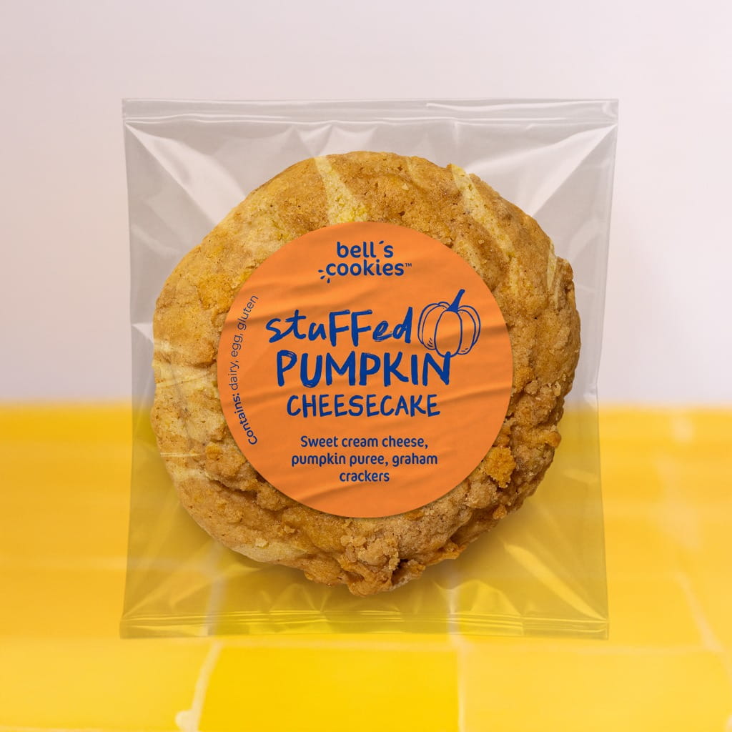 Bell's Cookies stuffed pumpkin cheesecake cookie in packaging on a yellow background