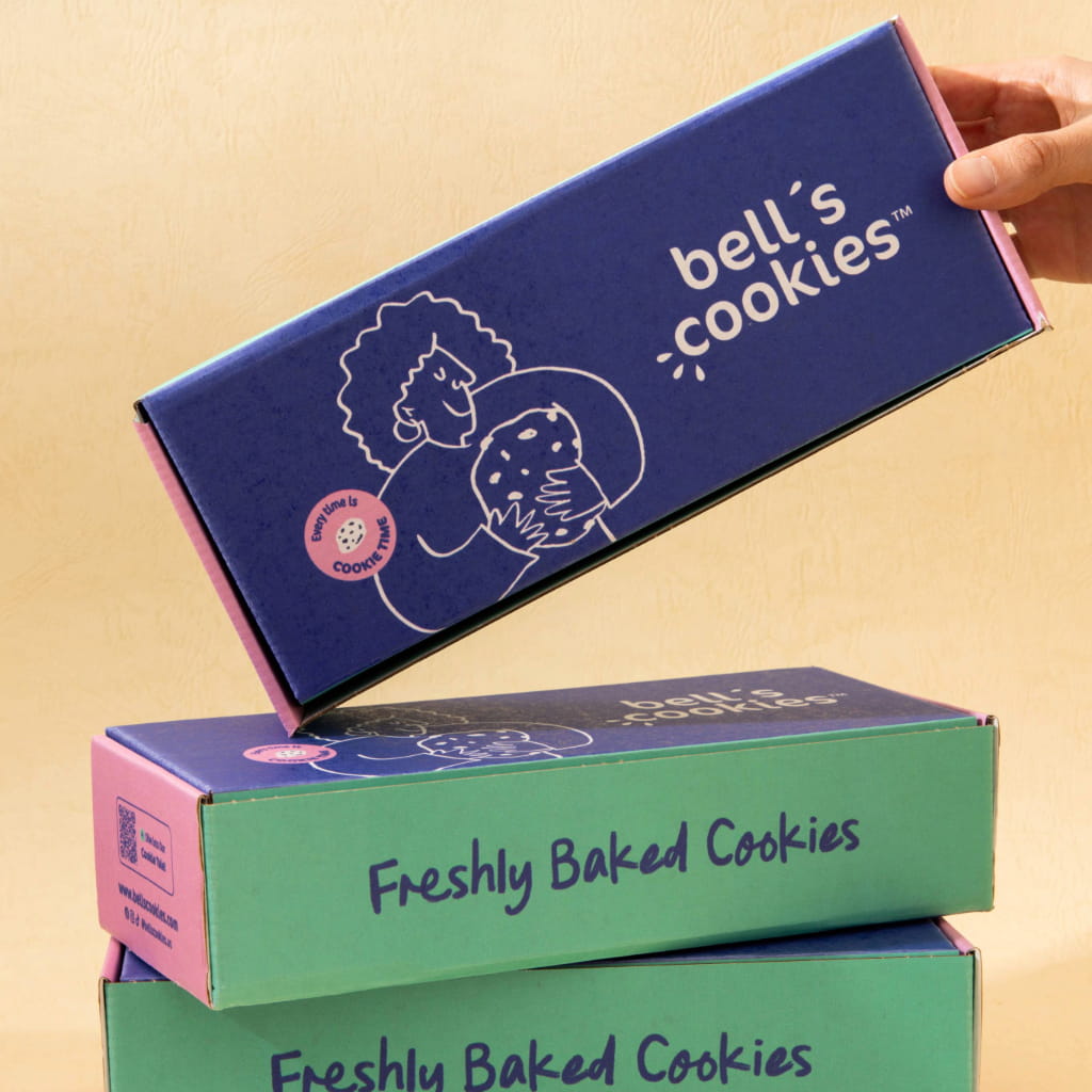 The vegan gluten free box with a hand taking a Confetti cookie